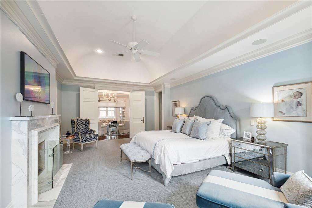 The peaceful, oversized primary bedroom has a sleek marble fireplace, built ins and space for two seating areas! The room exudes style and serenity…