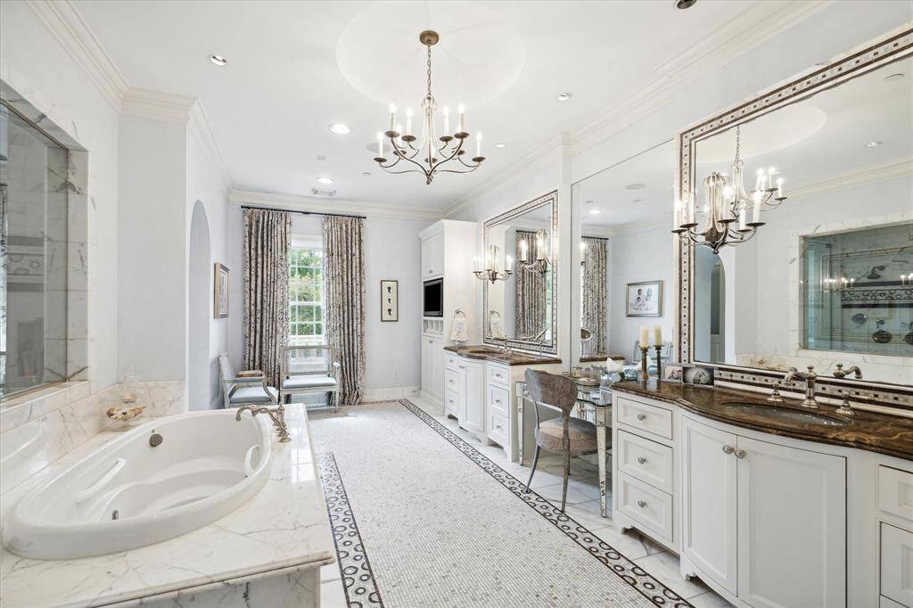 This spa-like primary bathroom has a dual walk in shower, large soaking tub, two oversized closets, two water closets and dual vanities plus a makeup area. Plenty of room for two to get ready at once!