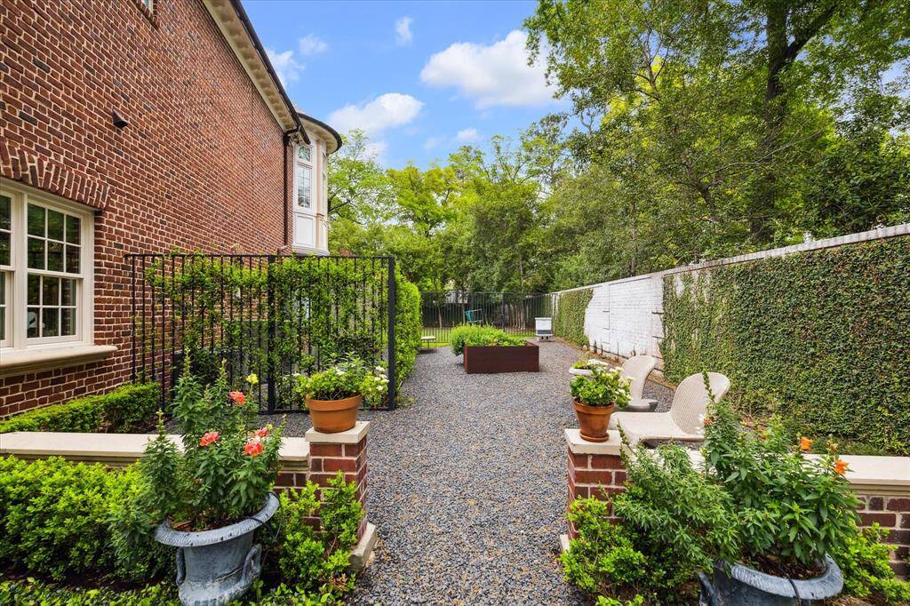 Private garden off of back green space next to the air conditioned single car garage. Behind the iron gates covered with ivy is a full house generator. Probably the largest generator you’ve seen for a residential home!