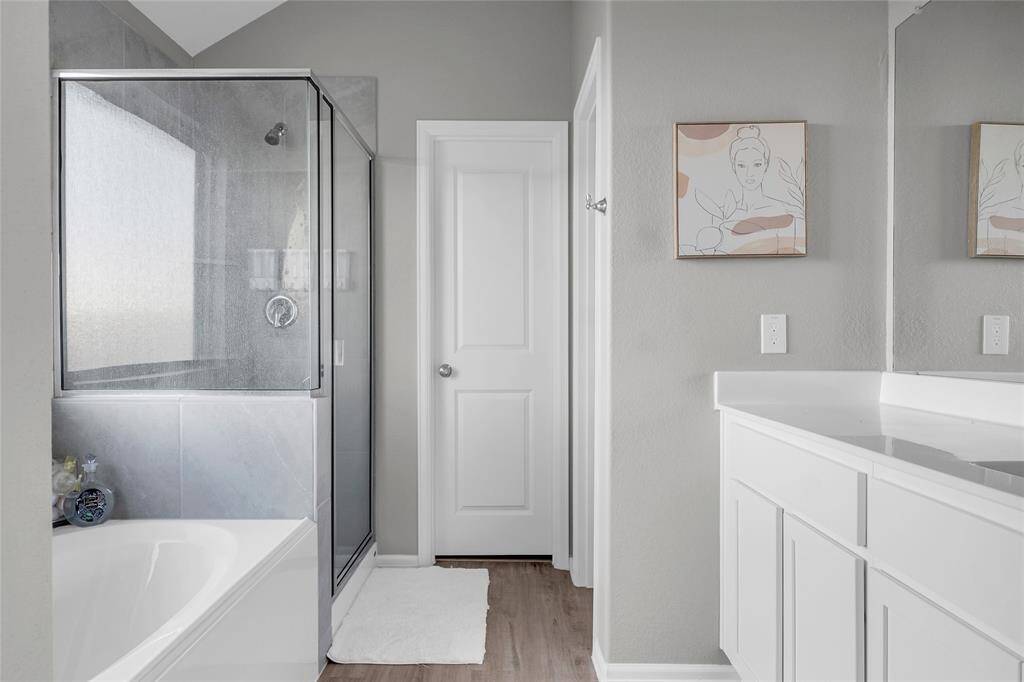 primary bath with soaking tub, and shower combo.