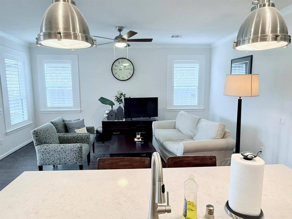 An open-concept gathering space, expertly crafted to be both comfortable for quiet evenings relaxing alone and spacious for hosting family visits and newfound friends from the neighborhood.