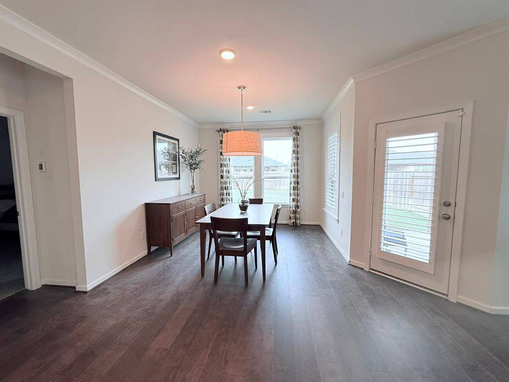 Dining Area with a View – Enjoy meals in the cozy dining space, seamlessly connected to the kitchen and living areas for effortless hosting.