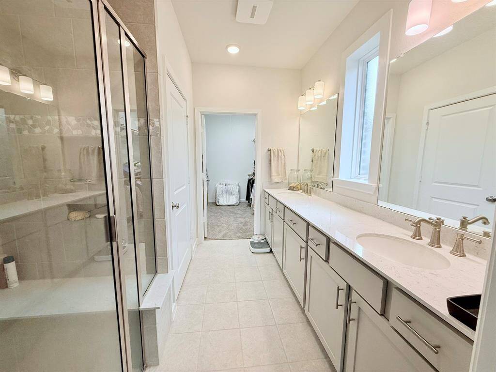 Luxurious Primary Bath – Unwind in the elegant primary bath with double sinks, a walk-in shower, and ample storage.