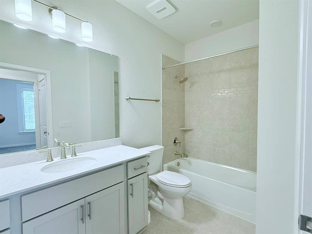 Guest Bathroom – Featuring a sleek design with a tub/shower combo and modern finishes.