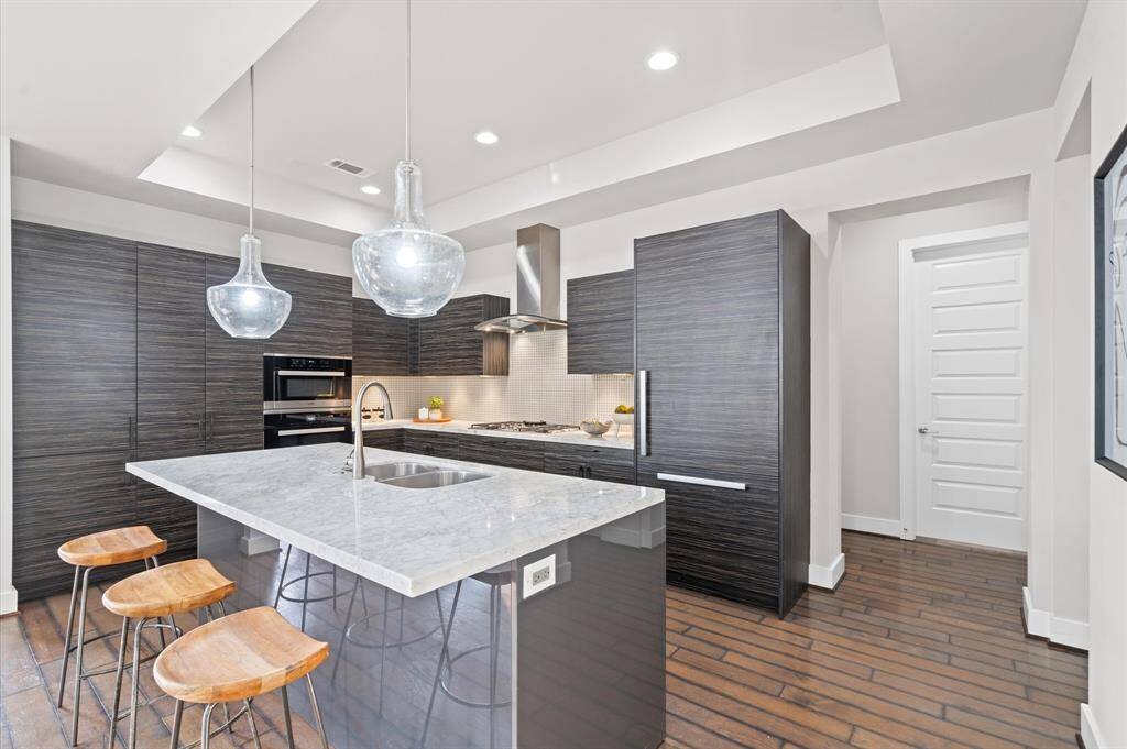 Modern elegance with a built-in Miele refrigerator, Eggersmann cabinets, and Carrara countertops throughout this stunning kitchen.