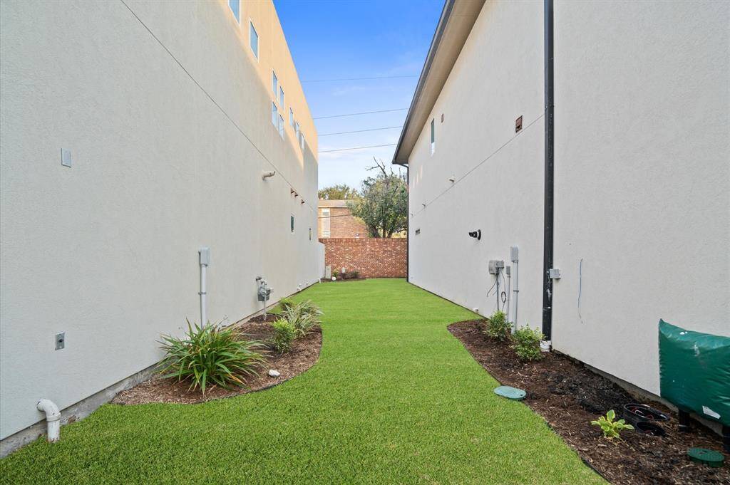 Unique to this subdivision, this home boasts a lush grass side patio, offering a rare green space in addition to the charming courtyard.