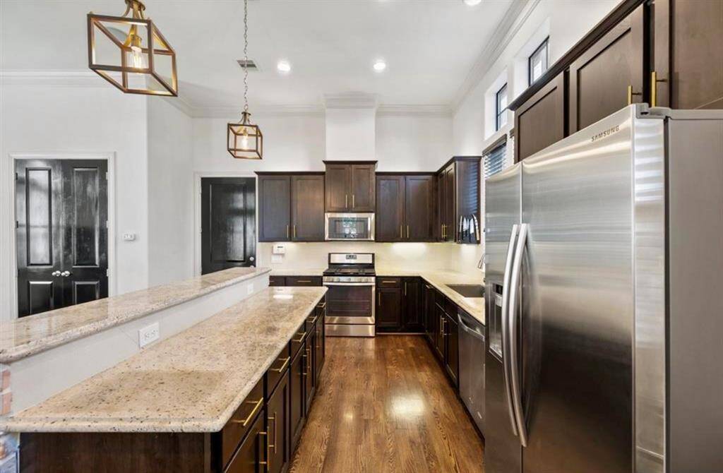 Take a closer look at the kitchen with modern finishes, sizable island, stainless steel appliances and under cabinet lighting.