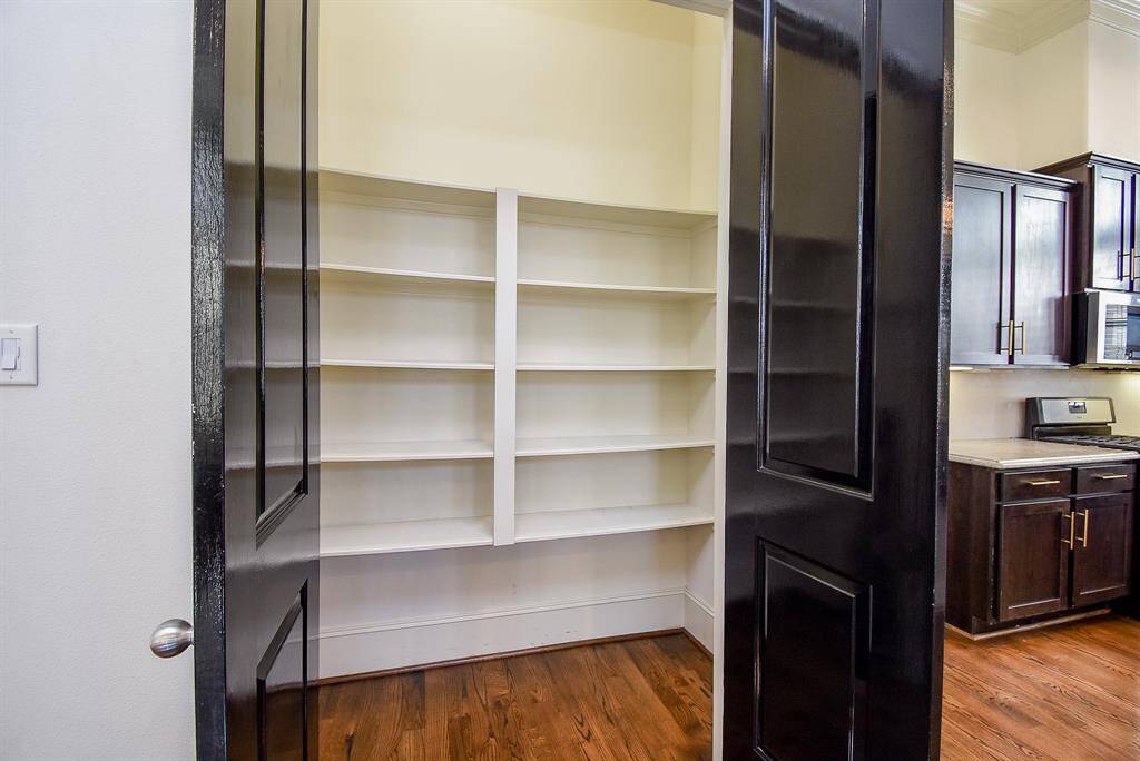 Pantry with spacious shelving, providing ample storage for various pantry items.