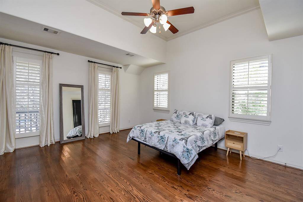 Welcome to the impressive primary suite on the second floor featuring tray ceiling, abundant natural light and gorgeous hardwood.