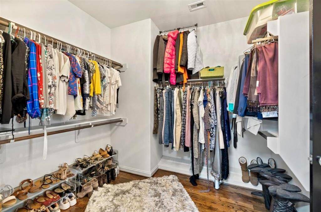 No, this is not one of the bedrooms... it is the HER closet! and it's even bigger in person. Designed in a way that is very useful and easy to get to everything.