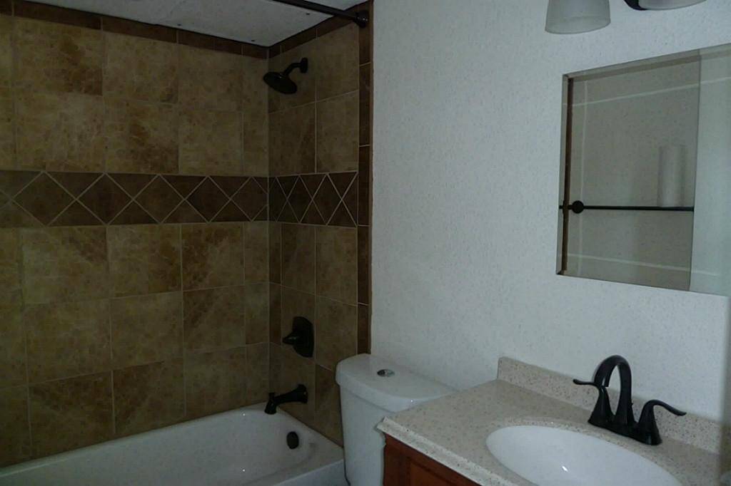 Updated first floor bath including tub, tile, sink, faucet & commode