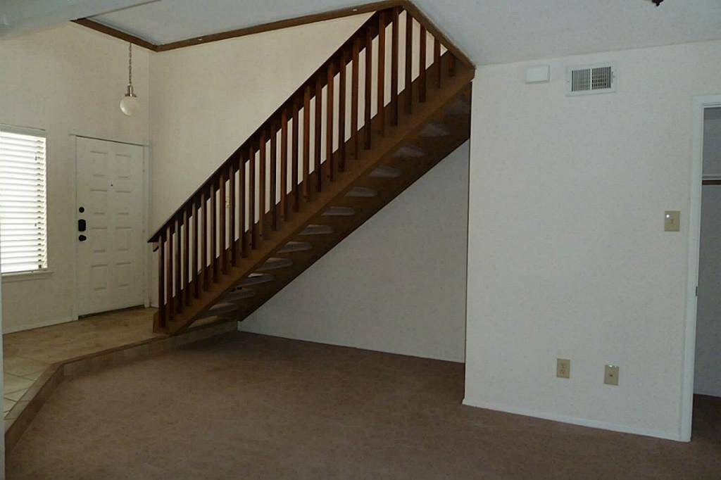 Staircase off front entry takes you to a spacious loft area and second bedroom and bath