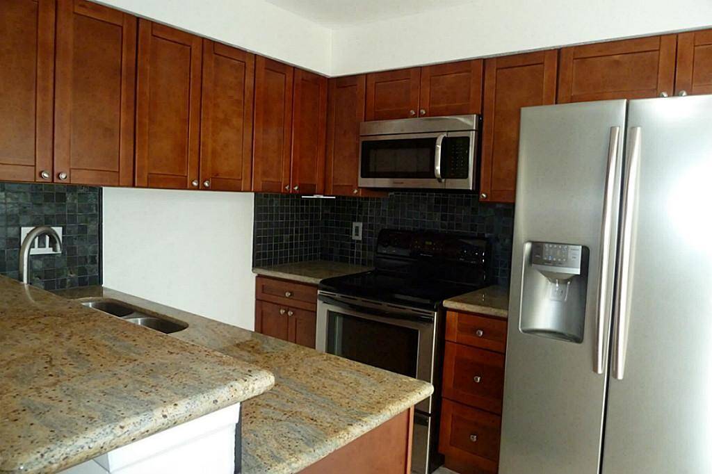 Granite breakfast bar and counters with tile floors. Refrigerator is included in the rent.
