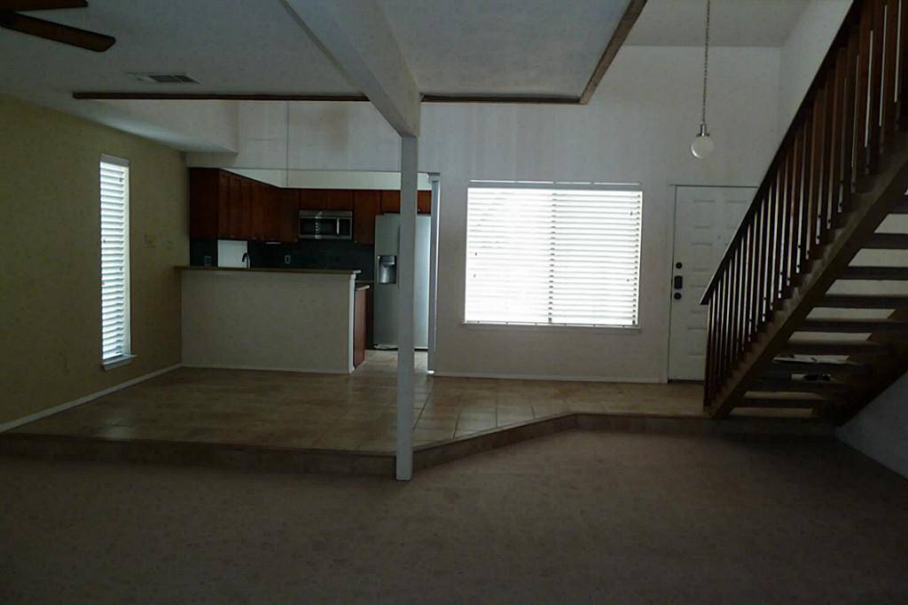 View from the first floor bedroom looking out to living area and kitchen
