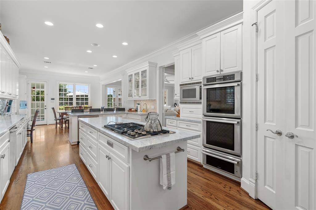 gourmet kitchenKitchen features white marble countertops, oversized island, two sinks, Wolf 5 burner gas cooktop, Thermador double ovens & warming drawer.