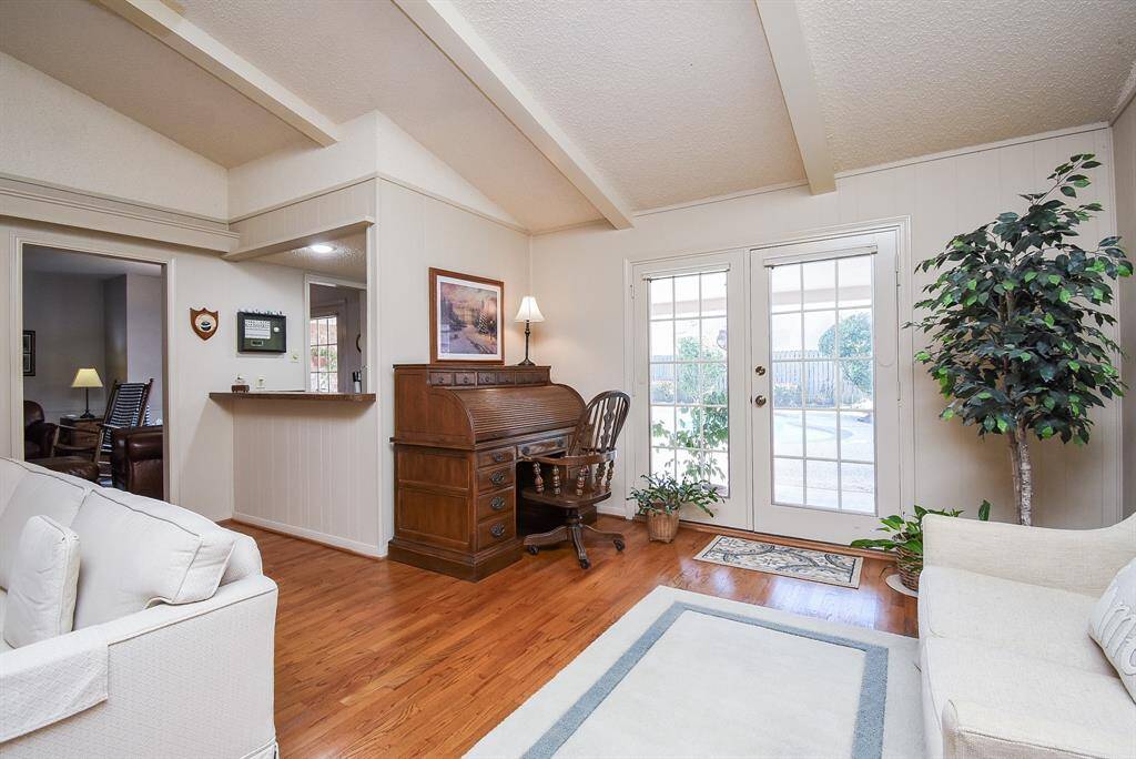Living room has additional sitting area that would make a great reading nook with french doors leading to back patio and pool. Wet bar in corner is great for entertaining