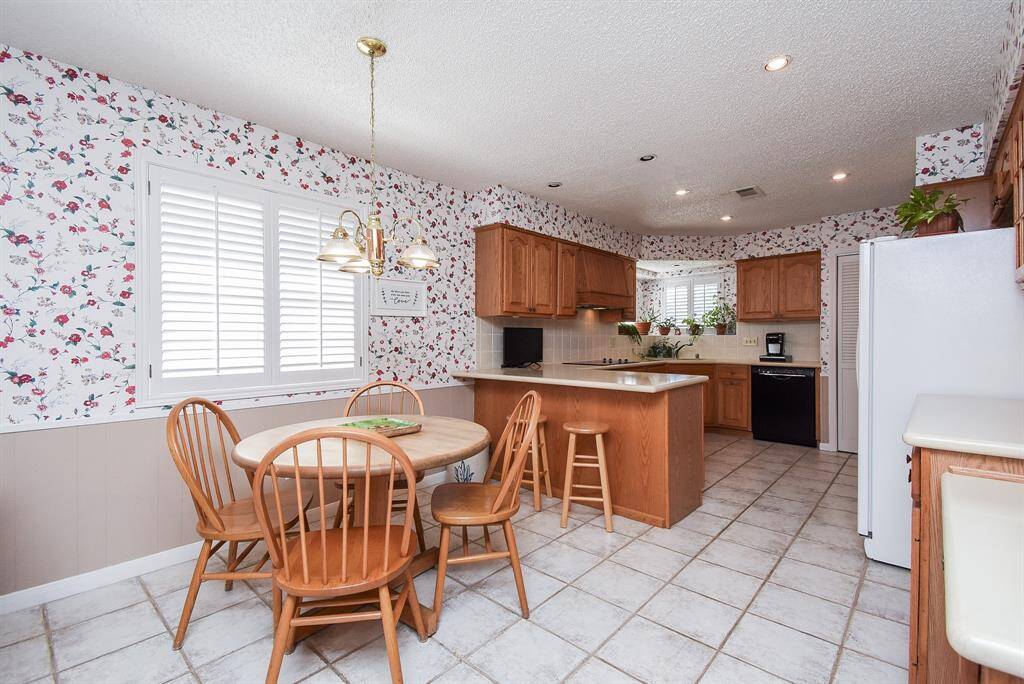Breakfast bar and room for large table in your informal dining area