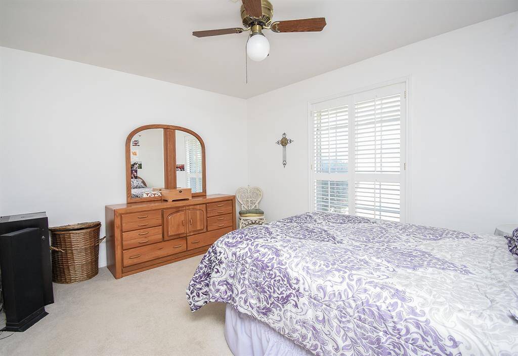 One  of the 3 secondary bedrooms with those awesome plantation shutters
