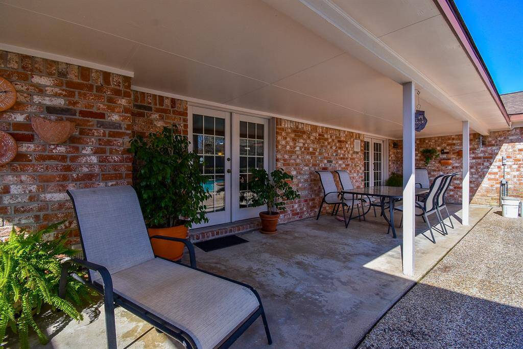 Long covered patio provides the shade you will want for our warm summers.  Notice the 2 sets of french doors that access your back patio