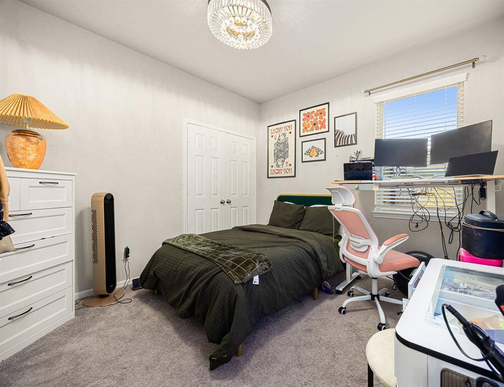 2nd downstairs bedroom with decorative lighting and closet