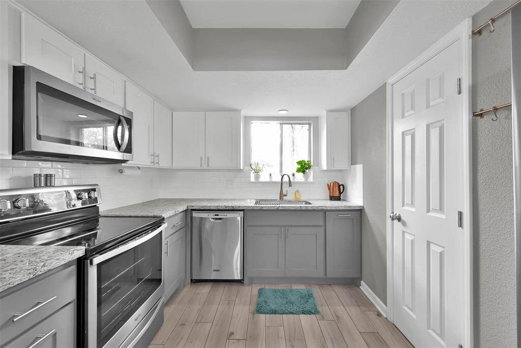The updated bright kitchen features updated cabinets, gorgeous granite counters and stainless appliances. Pantry for extra storage