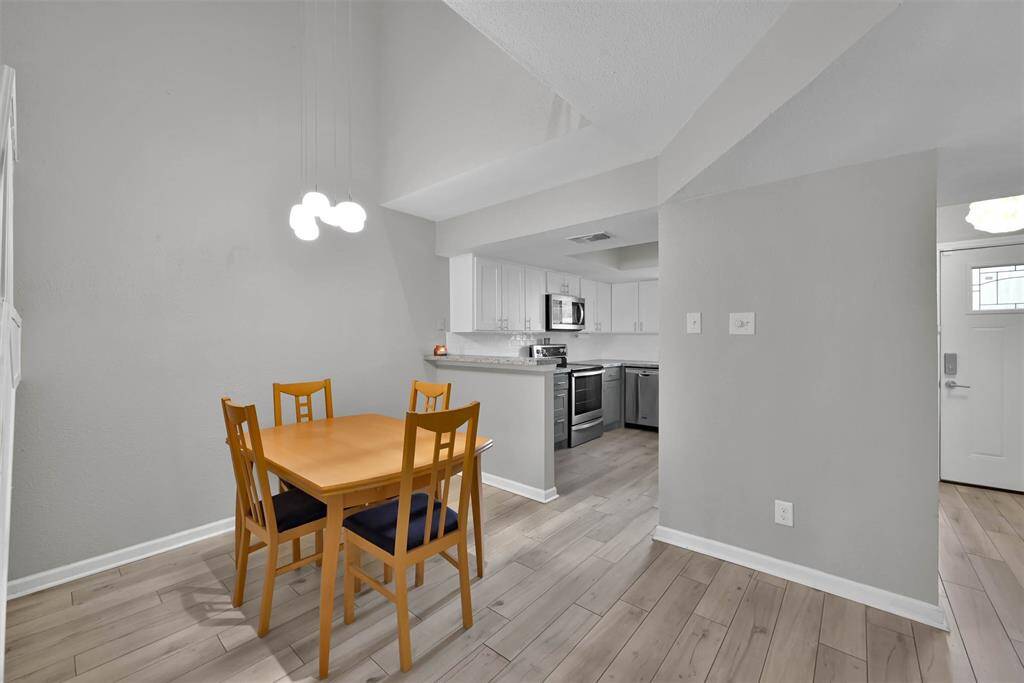 View of dining room into kitchen which faces the front of the condo