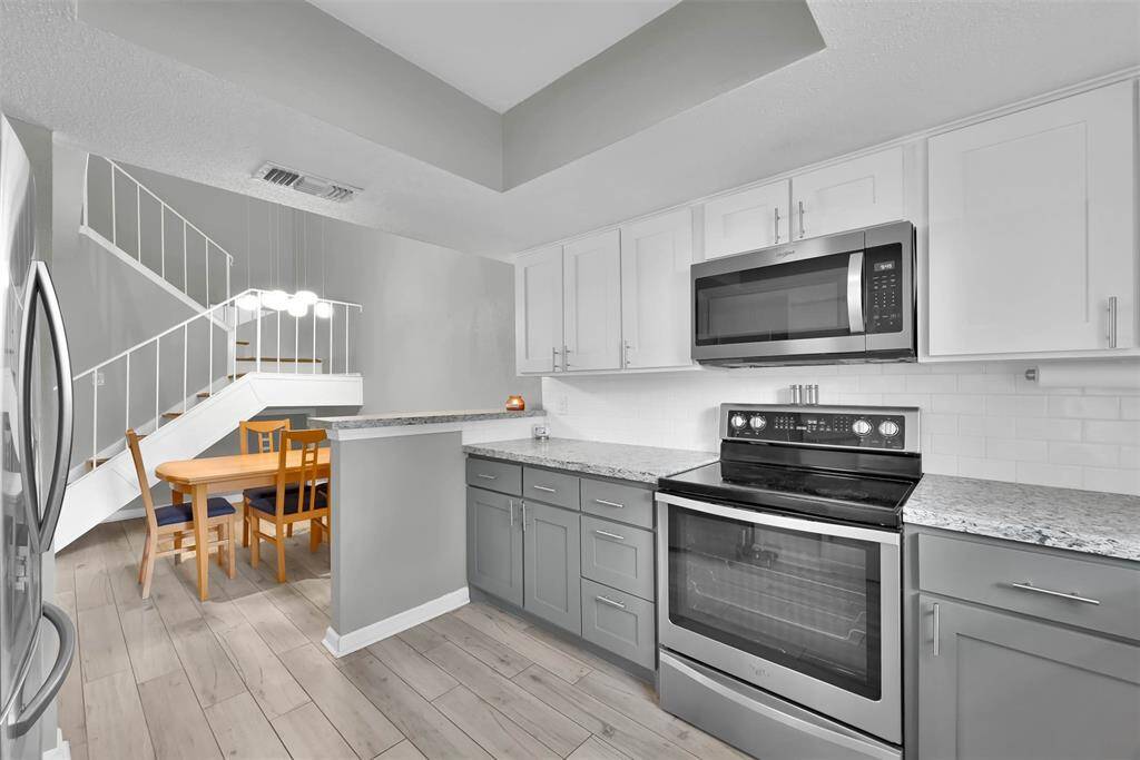 Stainless steel refrigerator stays with home.