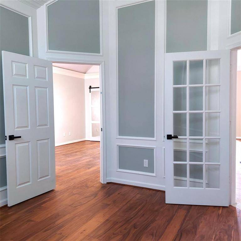 Natural light is a plus, in primary bedroom with crown molding, ceiling fan, engineered wood flooring, mirrored barn door , paint, everything is new! Access to office!