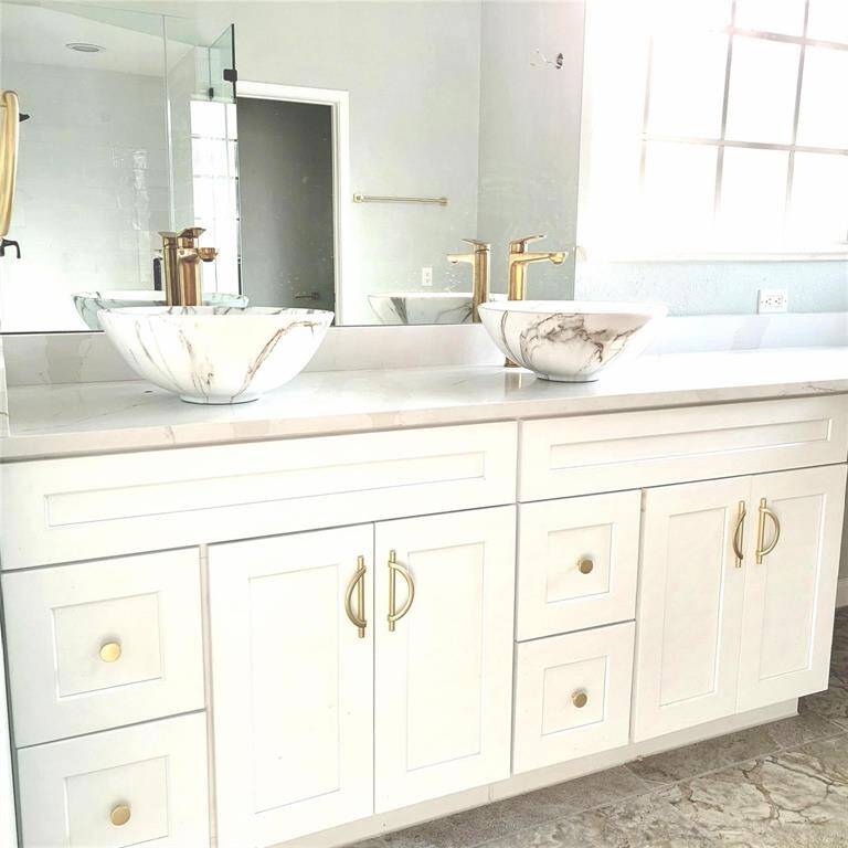 Primary bathroom with natural light, dressing area & new deep-soaking spa tub.