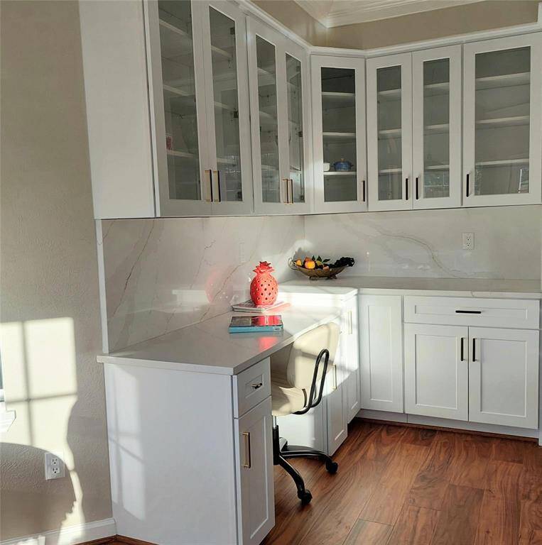 The kitchen and breakfast room have a welcome feel, with crown molding, painted walls, beautiful floors, and natural light.