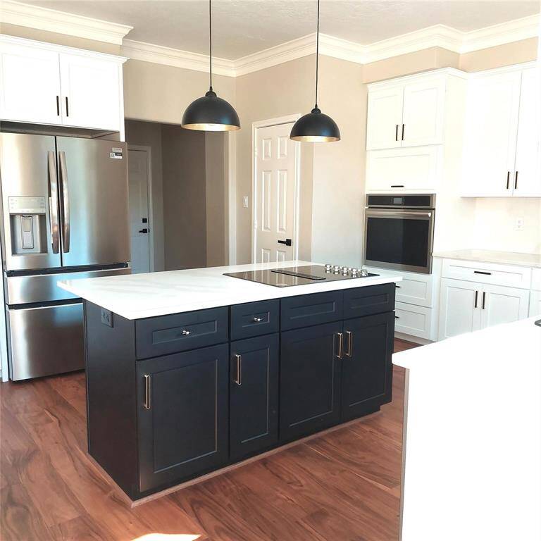 new sink, faucet, new hardware and cabinets new quartz countertops, backsplash and window sills