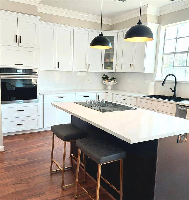 Laundry room now has a totally new look with travertine floors, a new cabinet and sink, and tons of extra storage space.