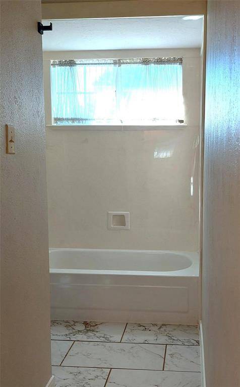 Bedroom 4 features new paint and recently updated doors and hardware. It also has lush carpeting.