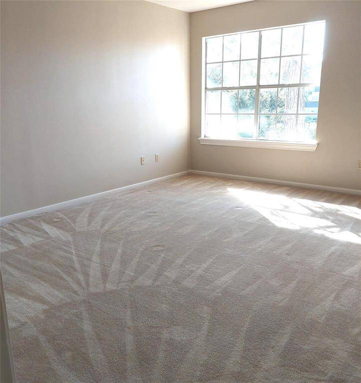 The seller has upgraded the three-car garage with epoxy flooring and added extra storage with new cabinets.