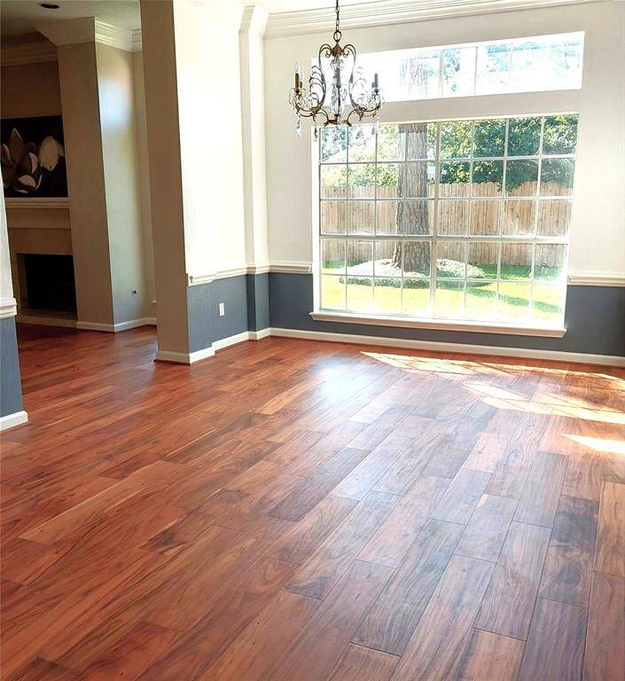 Crown molding accentuates the elegant atmosphere of this formal dining room. Beautiful engineered wood flooring gives this room a sleek, luxurious appearance.