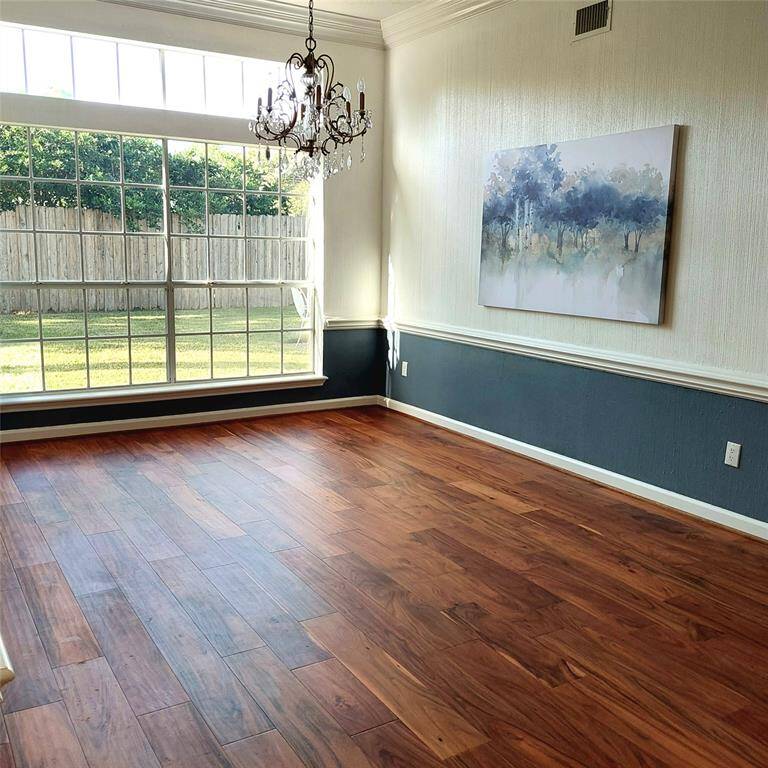 This picture can’t even begin to describe the beauty of this custom-painted wood-paneled office. With plantation shutters, engineered wood flooring, and two entry ways, this is an office you can be proud of.