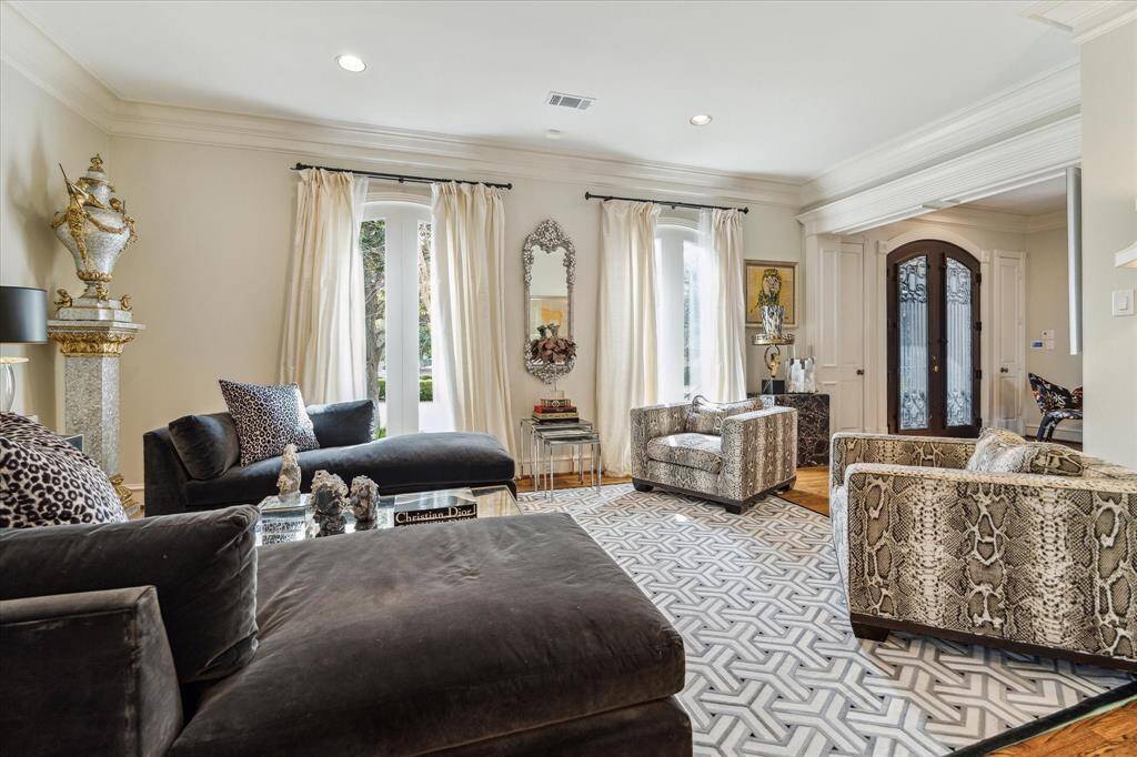 A grand 14” wide door casing seamlessly connects the living room to the foyer, creating an open and inviting flow. A hidden pocket door provides discreet access to the formal dining room, enhancing both functionality and charm.