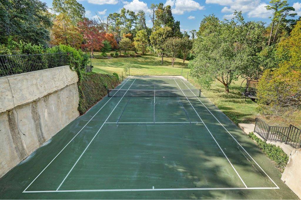 Calling all tennis and pickleball lovers! This luxury estate boasts a rare full-sized tennis court on a sprawling 17,554 sq ft lot, offering ample space for recreation and relaxation. Whether enjoying a match of tennis or pickleball, this private court elevates the outdoor experience at home.