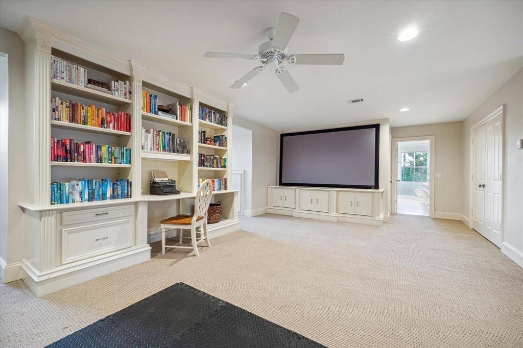 The third floor offers a wonderful guest suite with an ensuite bath and ample built-in storage. Neutral carpet adds warmth, while a ceiling fan ensures comfort. A built-in desk provides a convenient workspace, making this suite both functional and inviting.