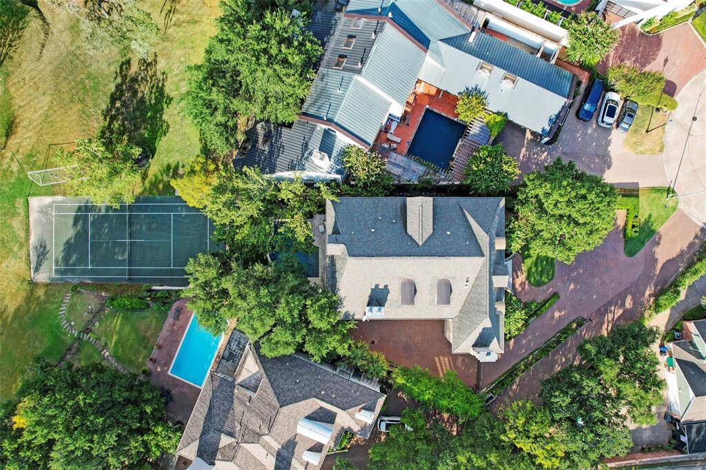 This resort-style backyard features a heated pool and spa with elegant fountain features, creating a tranquil oasis for relaxation and entertainment. The lush, year-round artificial turfed lawn and beautiful landscaping provide a stunning backdrop, while a covered patio offers the perfect space for outdoor dining and gatherings. Exterior cameras throughout the property ensure both security and peace of mind, blending luxury with practicality.