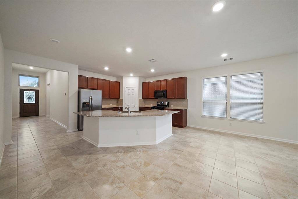 THREE full Bathrooms, 4 Big Bedrooms in Large 2019 classy KINGWOOD 1 story, 1 mile from Kwd Town Ctr. Lotta Shops/Food! Pic.shows combined Kitchen, Breakfast AND DEN into 1 large 35 ft. GREAT ROOM. 8 seat at flat granite triangular counter to eat; Wa/Dryr/Frig STAY. Kids go to 3 MOST PREFERRED Kwd Schools! Large Patio/Back Gate opens to woods. LOW UTILITIES: Elec <$!00/m. Water <$50/m. Gas<$30/m. GREAT Kwd Amenities Fast Exit/ParcNRide to Bush/Downtown.