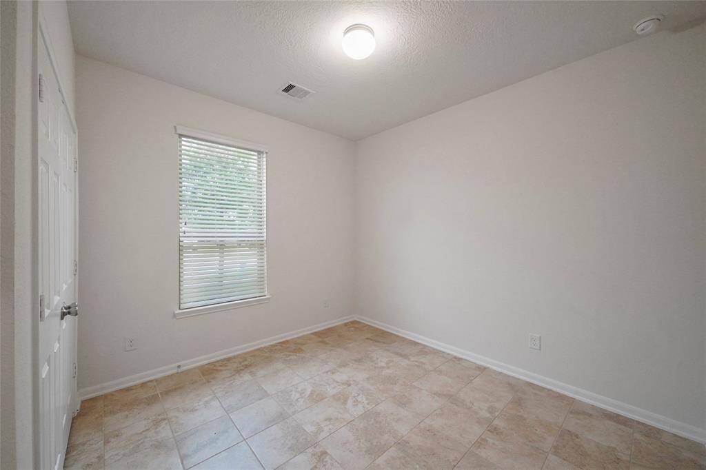 2nd full Bedroom at front of home, with its own Closet right next door to double Bathroom.  With EZ clean tile flooring & 2 in. Custom blinds. Great view of front yard and Entrance, sometimes used as an office, 9 ft ceilings and  lots light.   These days no center fan is required as each room has its own separate IN and OUT Vents in ceiling to circulate the air in the modern way!  Yeah!