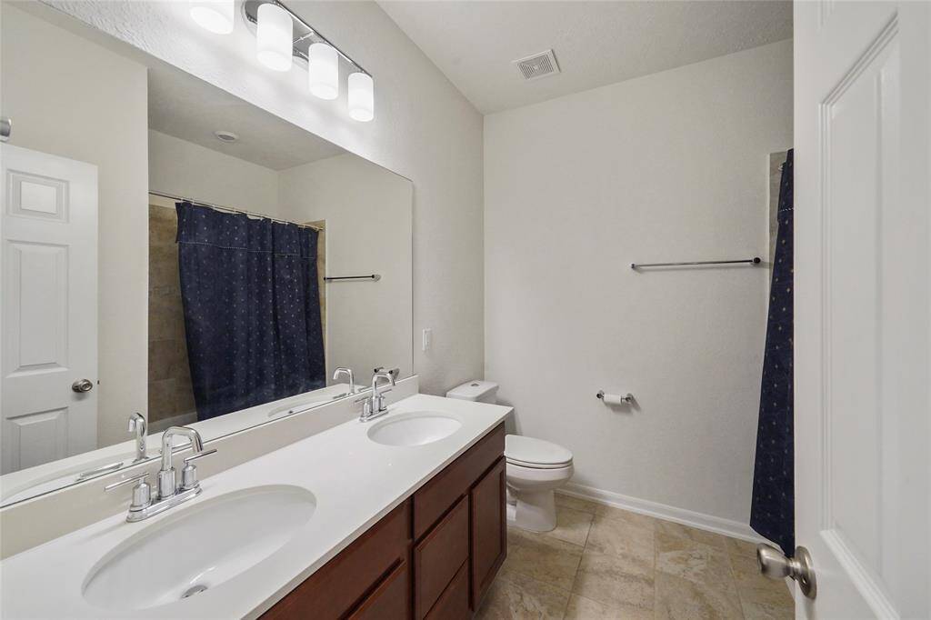 3rd FULL Bathroom, with UNDERMOUNT double sinks set in QUARTZ counter tops. Low step tub with shower makes for EZ choices to wash yr dog or baby in, OR BOTH. Tile floor, modern lighting all makes this an EZ room to use and clean.