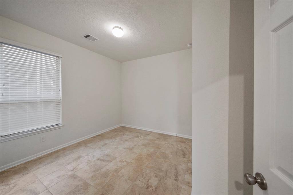 3rd full Bedroom, other side of full Bathroom, has its own window to  side yard, and very EZ access to Bathroom between!  Same tile floor, 9 ft ceilings, & large closet, for full family use.