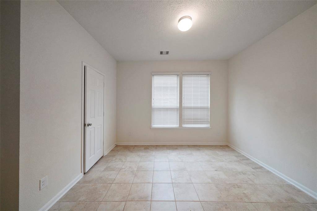 4th Bedroom with its own full private ensuite Bathroom; same benefits, all tile, 9 ft ceilings, and nice walk-in Closet  for lots clothing. Bathroom shows at left front of photo.