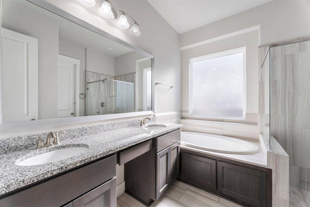 Primary bath has double vanities.