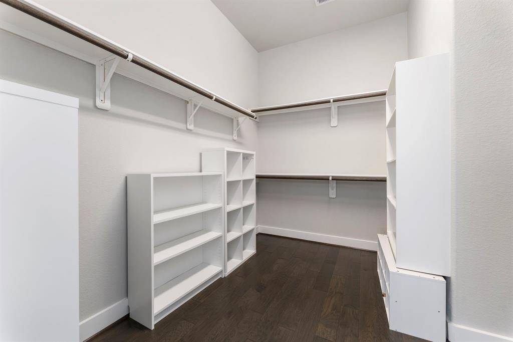 Walk in closet inside primary bathroom.