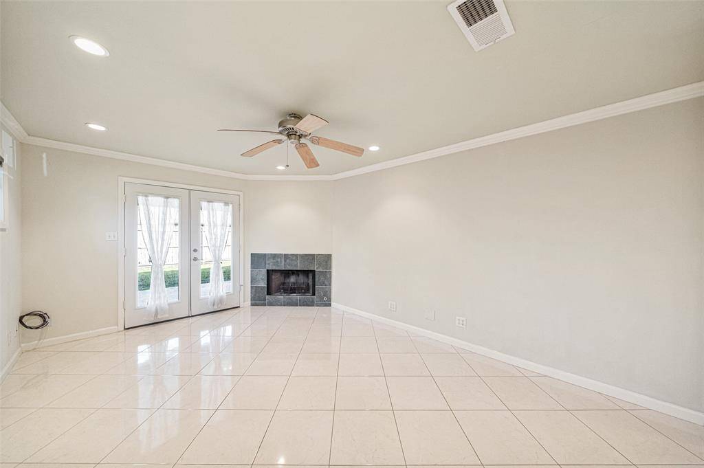 Well appointed fireplace with a slate surround brings warmth and charm to the living room, embrace cozy evenings at home.