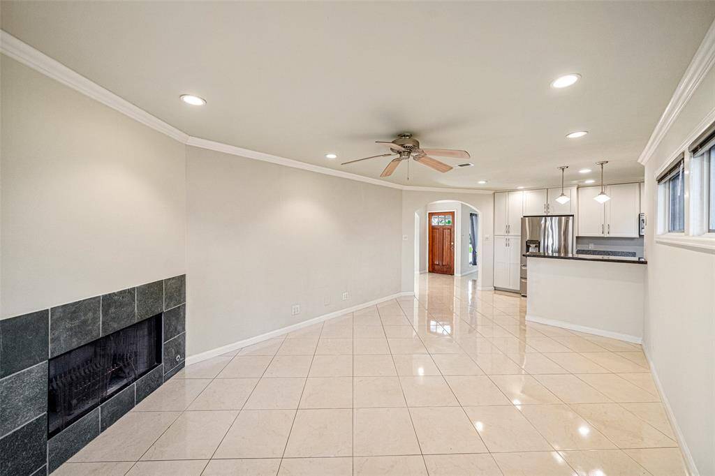From this vantage point at the porch door, you'll find plenty of living space and a cozy breakfast bar in the kitchen.