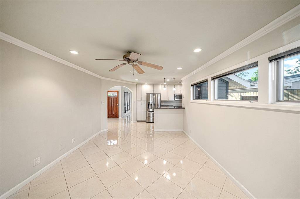 Polished tile seamlessly connects the living room and kitchen, experience the perfect blend of style and functionality.